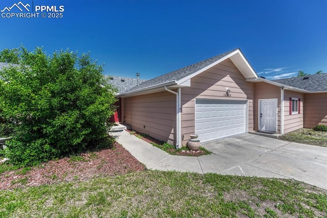 16440 Eastonville Rd, Elbert, CO 80106 - view of home's exterior featuring an attached garage, concrete driveway, and roof with shingles
