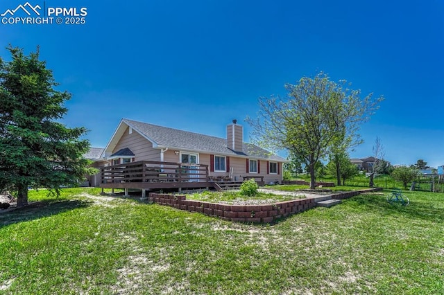 16440 Eastonville Rd, Elbert, CO 80106 - rear view of house featuring a deck, a chimney, and a lawn