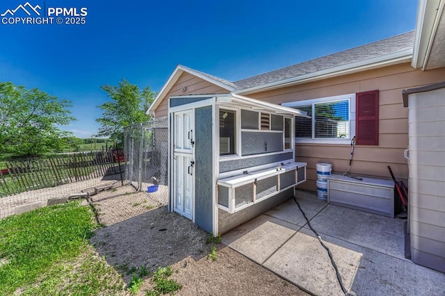 16440 Eastonville Rd, Elbert, CO 80106 - view of side of home with a patio area, an outbuilding, and roof with shingles