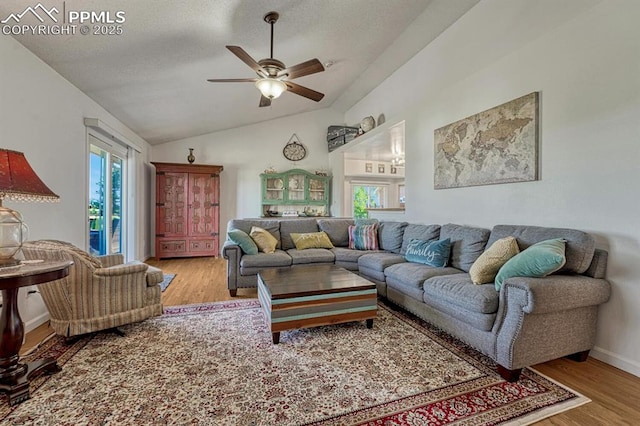 16440 Eastonville Rd, Elbert, CO 80106 - living room featuring wood finished floors, plenty of natural light, ceiling fan, vaulted ceiling, and a textured ceiling