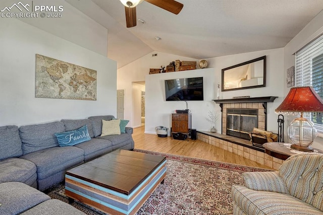 16440 Eastonville Rd, Elbert, CO 80106 - living room with vaulted ceiling, wood finished floors, a ceiling fan, and a fireplace