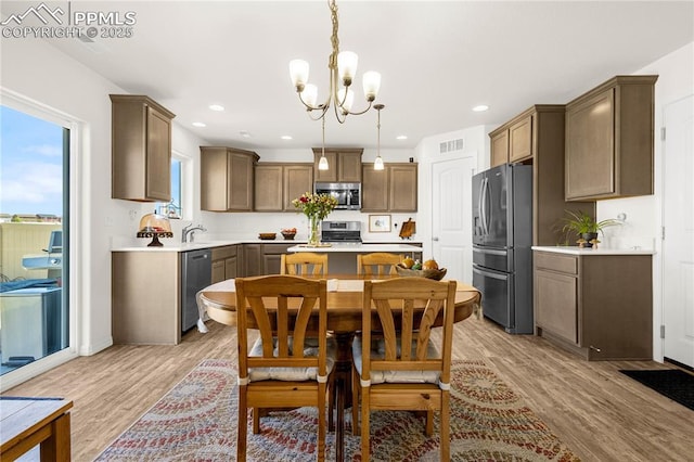 dining space featuring recessed lighting, a chandelier, visible vents, and light wood-style flooring