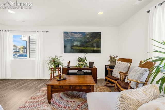 living area with recessed lighting, baseboards, and wood finished floors