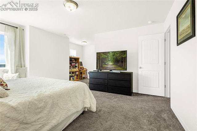 carpeted bedroom featuring baseboards