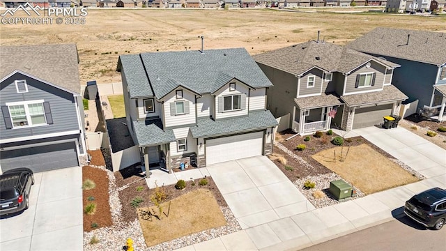 view of front of property featuring stone siding, a residential view, a garage, driveway, and roof with shingles