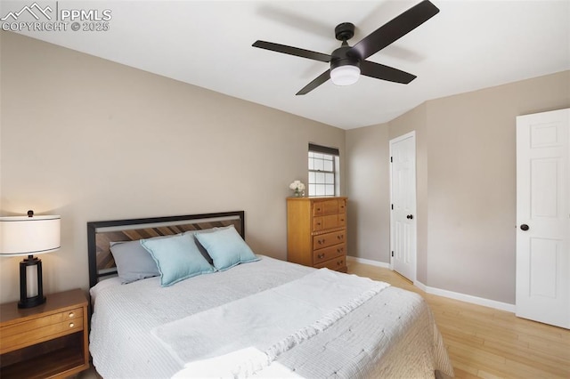 bedroom with ceiling fan, baseboards, and light wood-style floors
