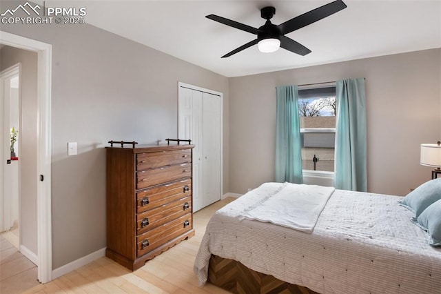 bedroom with light wood finished floors, a closet, baseboards, and a ceiling fan