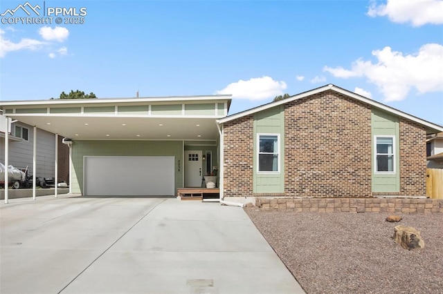 view of front of home with brick siding, driveway, and a garage