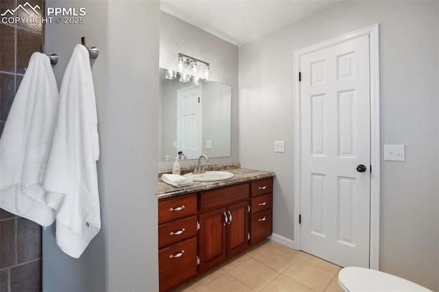 bathroom featuring toilet, tile patterned flooring, and vanity
