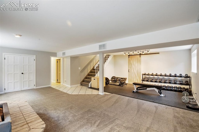 workout room with baseboards, visible vents, and carpet