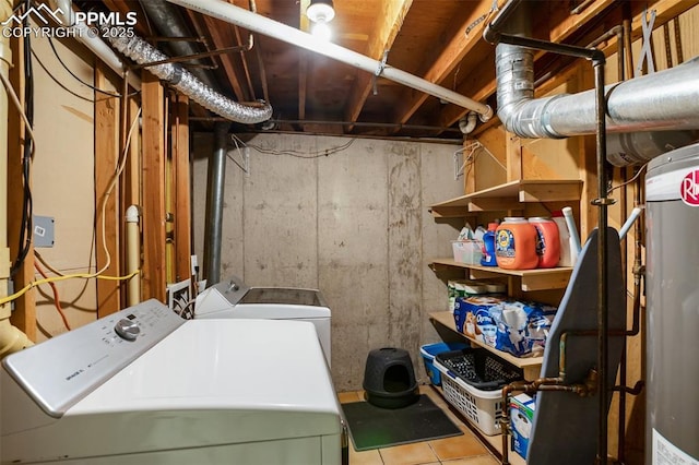 clothes washing area featuring separate washer and dryer, laundry area, and tile patterned floors