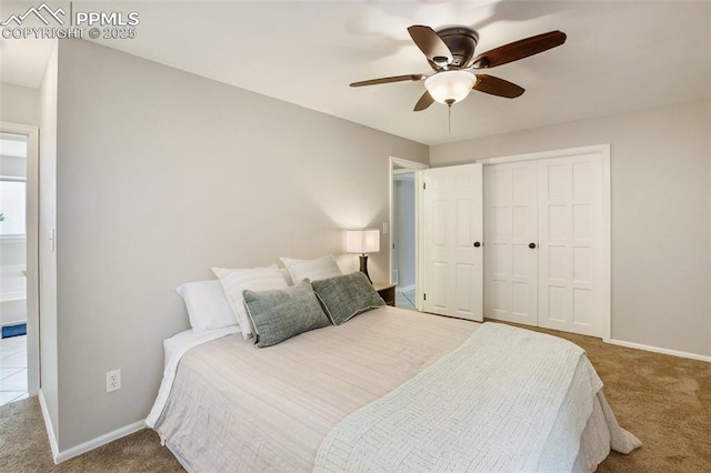bedroom featuring carpet flooring, a closet, baseboards, and a ceiling fan