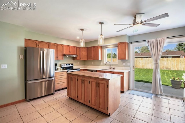 kitchen featuring a ceiling fan, a sink, under cabinet range hood, light countertops, and appliances with stainless steel finishes