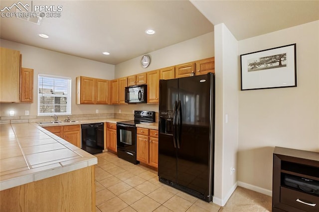kitchen featuring a sink, light tile patterned floors, black appliances, tile counters, and recessed lighting