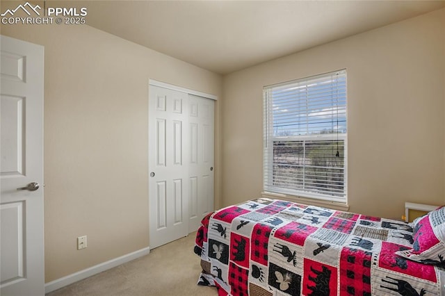 bedroom with baseboards, light colored carpet, and a closet