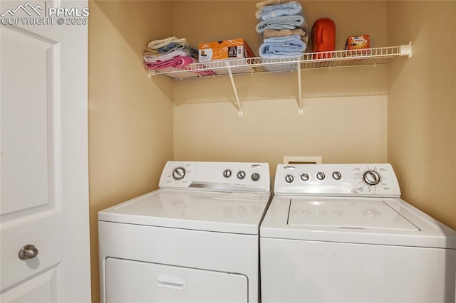laundry room featuring separate washer and dryer and laundry area