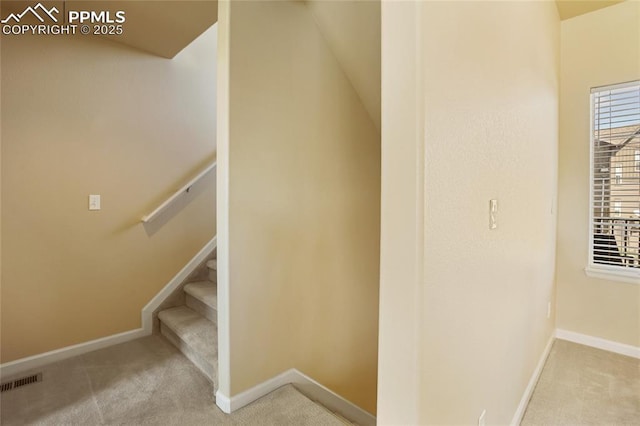 staircase featuring baseboards, carpet, and visible vents