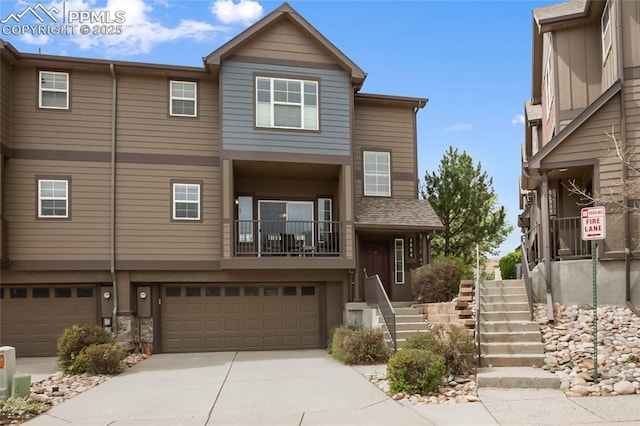 townhome / multi-family property featuring concrete driveway, stairway, and a garage