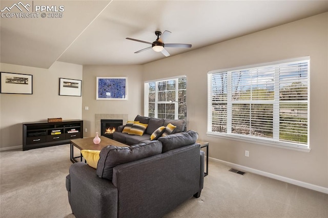 living room featuring baseboards, light colored carpet, and visible vents
