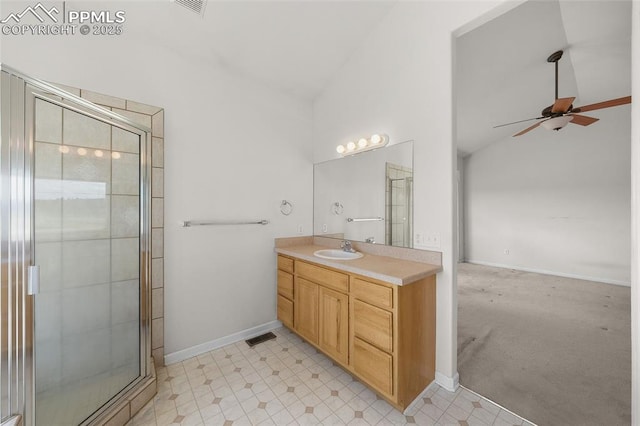 bathroom with vanity, a ceiling fan, visible vents, and a stall shower
