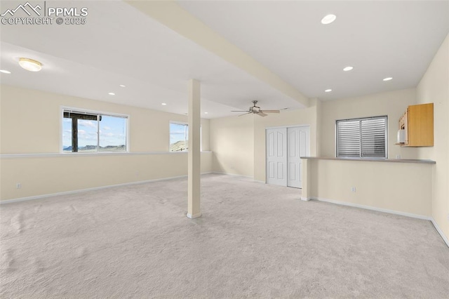 basement with baseboards, ceiling fan, carpet, and recessed lighting