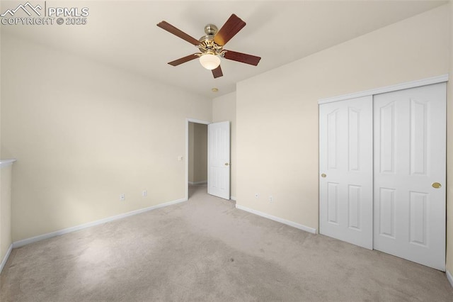 unfurnished bedroom with baseboards, a ceiling fan, a closet, and light colored carpet