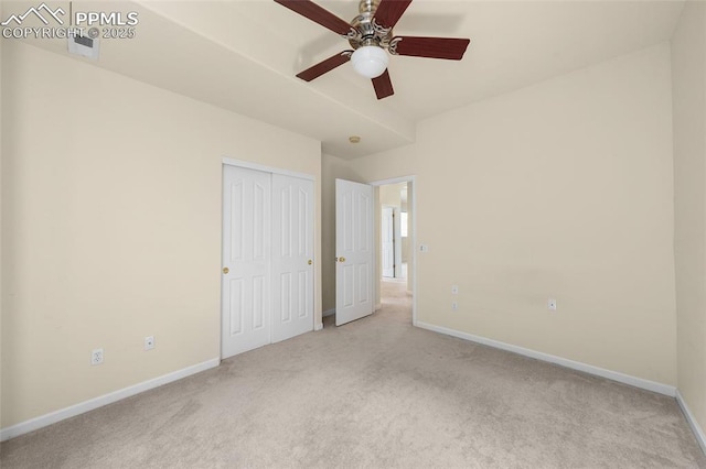 unfurnished bedroom with baseboards, carpet, and a closet