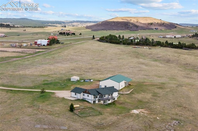 birds eye view of property featuring a rural view and a mountain view