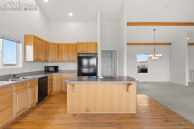kitchen with high vaulted ceiling, a healthy amount of sunlight, a sink, and black appliances