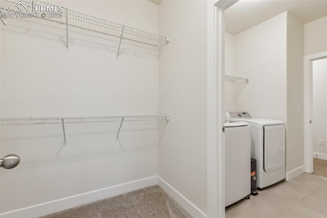 laundry area with baseboards and washer and clothes dryer