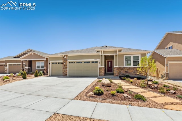 view of front of house with an attached garage, driveway, and stone siding