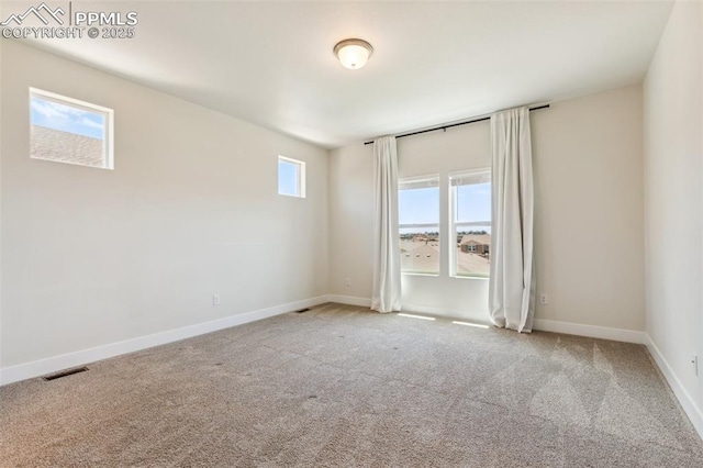 empty room with carpet and baseboards