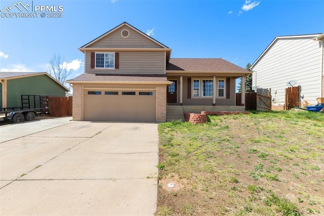 view of front of property with brick siding, fence, driveway, and a garage