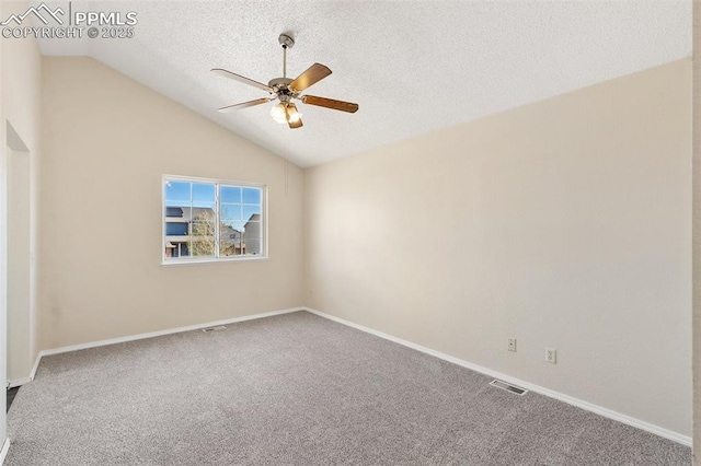 unfurnished room with vaulted ceiling, carpet, a ceiling fan, and visible vents