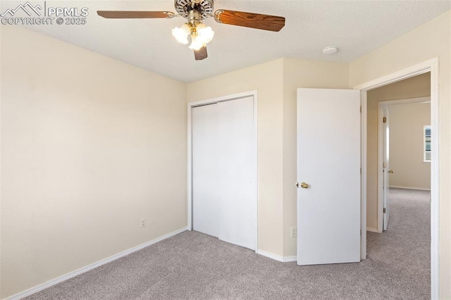 unfurnished bedroom with carpet flooring, baseboards, ceiling fan, and a closet