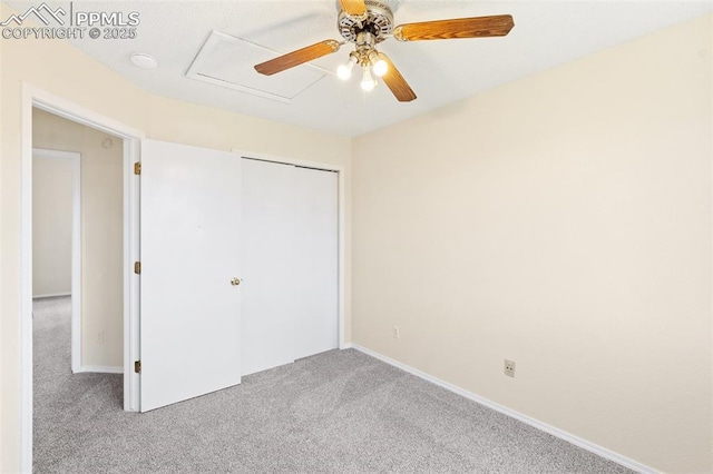 unfurnished bedroom featuring carpet floors, a ceiling fan, baseboards, and a closet