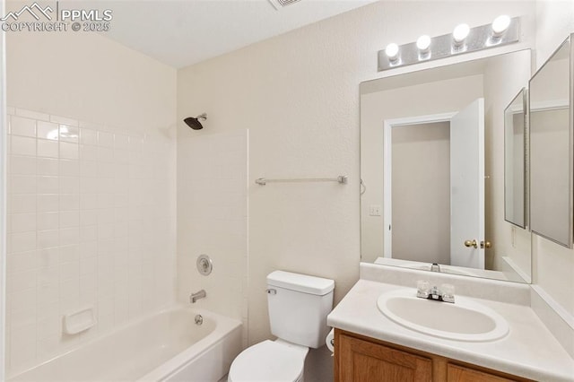 full bathroom featuring washtub / shower combination, vanity, and toilet