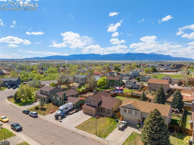 birds eye view of property with a mountain view and a residential view