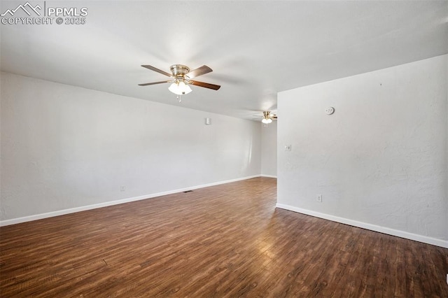 empty room featuring baseboards, a ceiling fan, and wood finished floors