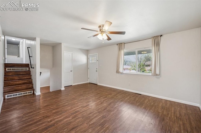 unfurnished living room featuring ceiling fan, visible vents, wood finished floors, baseboards, and stairs