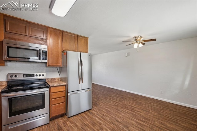 kitchen with ceiling fan, brown cabinetry, stainless steel appliances, baseboards, and wood finished floors
