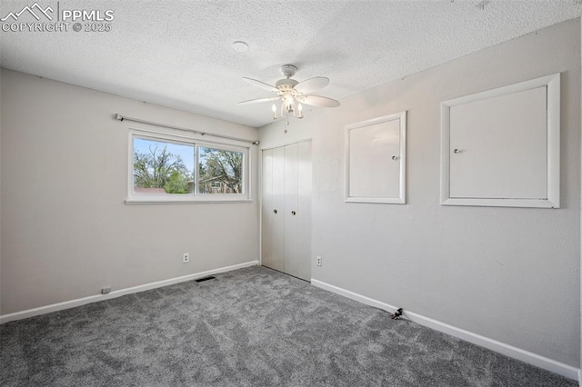 unfurnished room with baseboards, a ceiling fan, carpet flooring, and visible vents