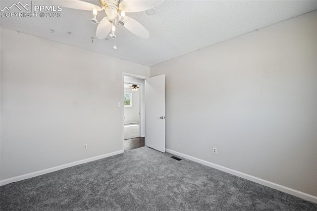 carpeted spare room with ceiling fan, visible vents, and baseboards