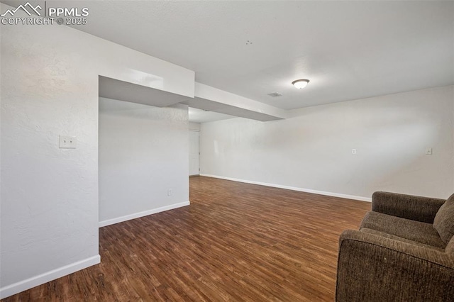 finished basement featuring baseboards and wood finished floors