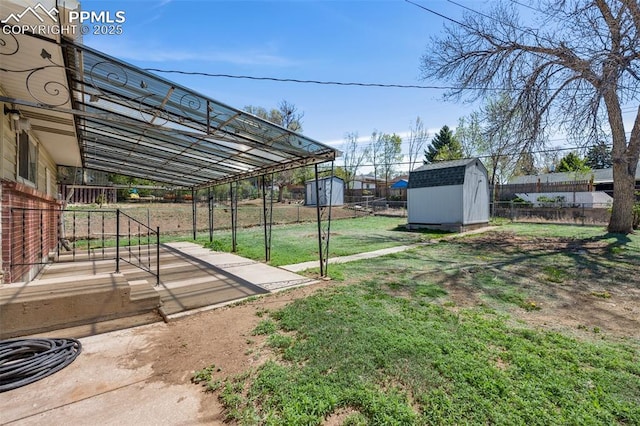 view of yard featuring an outdoor structure, a patio, a shed, and a fenced backyard