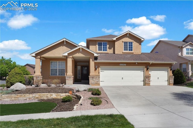 4282 Thornbury Way, Colorado Springs, CO 80922 - view of front facade with stucco siding, concrete driveway, and a garage