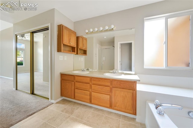 4282 Thornbury Way, Colorado Springs, CO 80922 - full bath featuring double vanity, tile patterned floors, a bath, and a shower