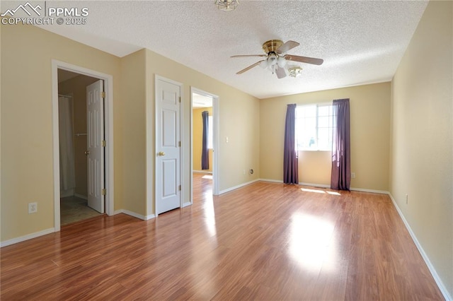 4282 Thornbury Way, Colorado Springs, CO 80922 - unfurnished room featuring a textured ceiling, wood finished floors, ceiling fan, and baseboards