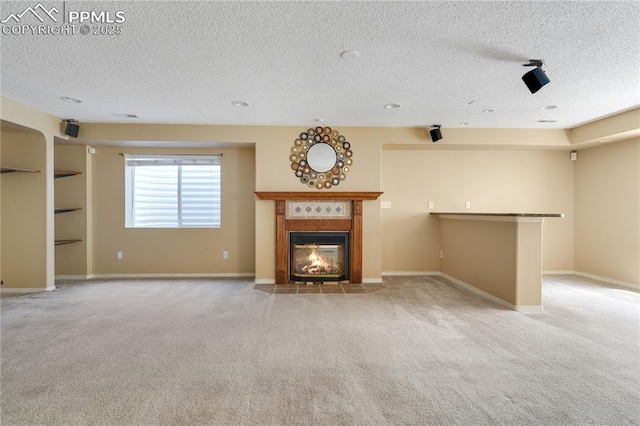 4282 Thornbury Way, Colorado Springs, CO 80922 - unfurnished living room featuring a textured ceiling, carpet flooring, a fireplace with flush hearth, and baseboards