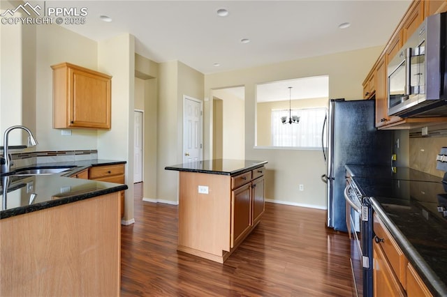 4282 Thornbury Way, Colorado Springs, CO 80922 - kitchen featuring a sink, appliances with stainless steel finishes, a center island, dark wood finished floors, and recessed lighting